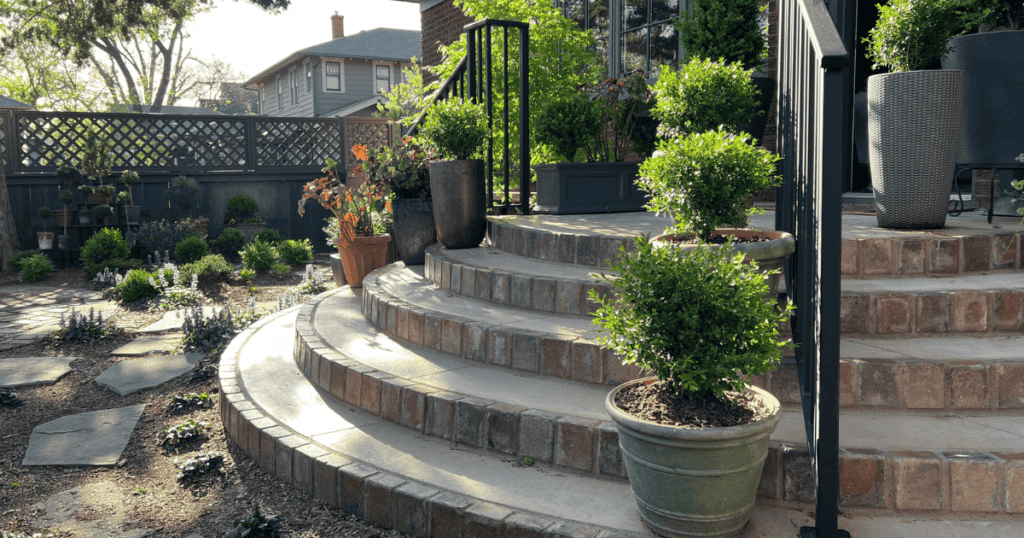 container planted Better Boxwoods framing stairs